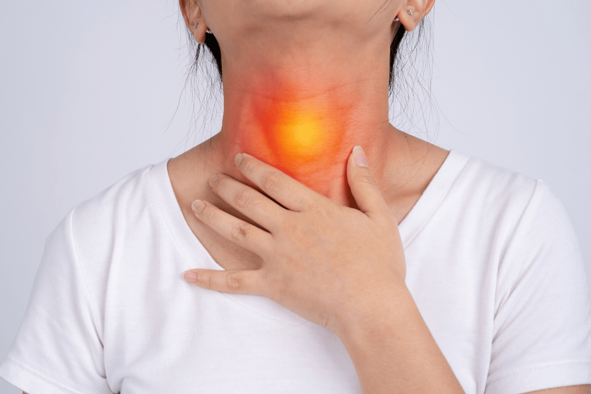 Woman touching her throat with highlighted inflammation or pain in the neck area.