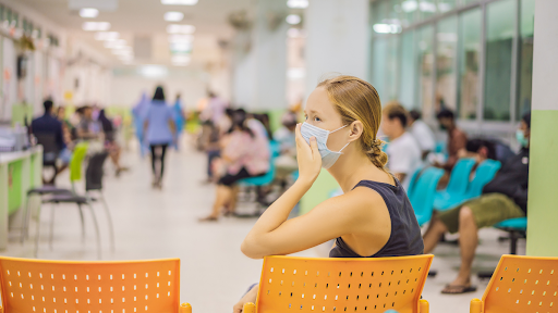 Woman wearing face mask waiting in Urgent Care