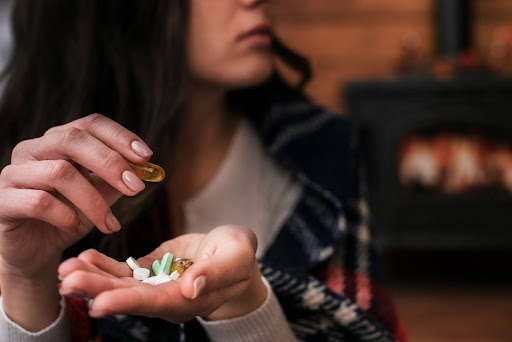 A woman holding pills in her hand