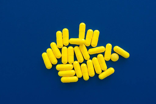 Yellow capsule on blue background.